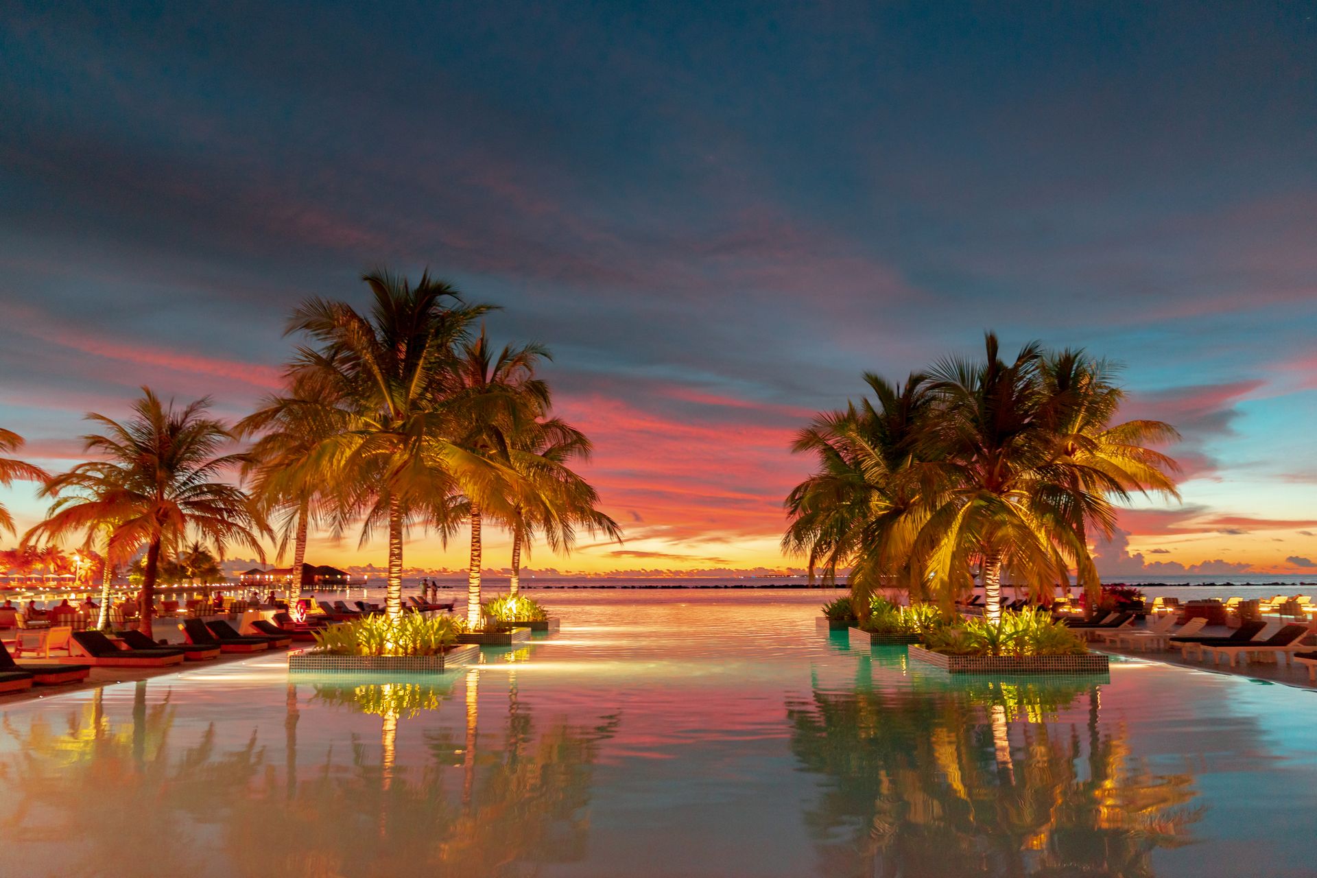 Luxury resort pool at sunset